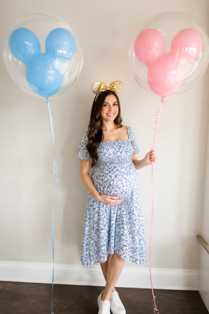 Hold Blue and Pink Disney Balloons Over Your Bump